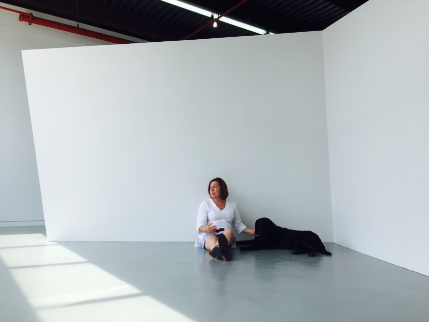 Gallerist Ellen Hackl Fagan and her dog in front of a sculpture by Thomas Lendvai