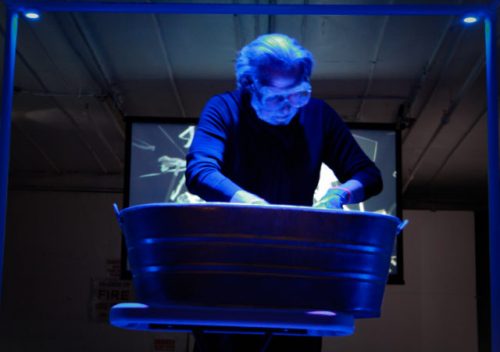 A person sitting in front of a piano Description automatically generated