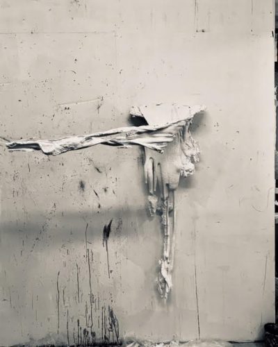 A picture containing building, white, black, standing Description automatically generated