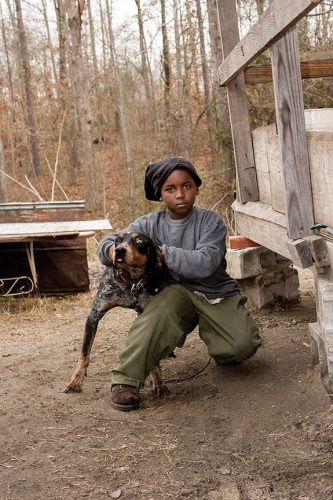 A picture containing outdoor, sitting, brown, man Description automatically generated