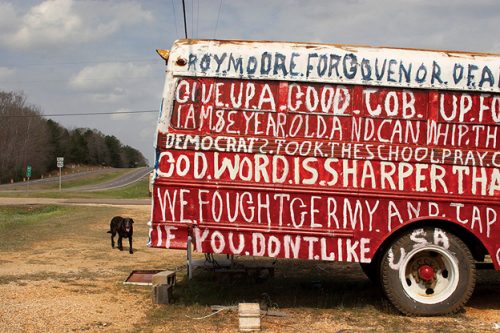 A sign on the side of a truck Description automatically generated