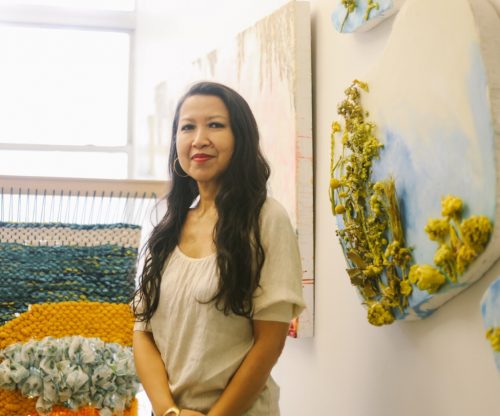 A person in a yellow dress posing for a picture Description automatically generated