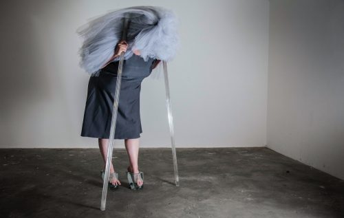 A person standing in a room Description automatically generated