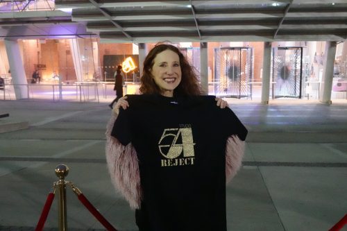 A person standing in front of a building Description automatically generated