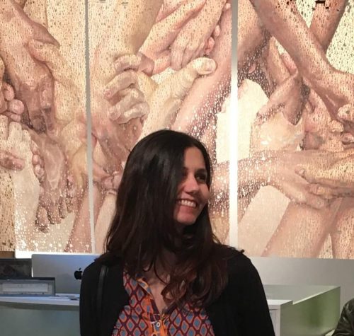 A person standing in front of a curtain Description automatically generated