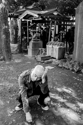 A group of people walking down a dirt road Description automatically generated