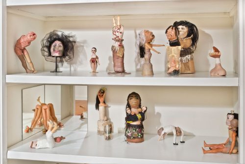 A collection of figurines on a shelf Description automatically generated with medium confidence