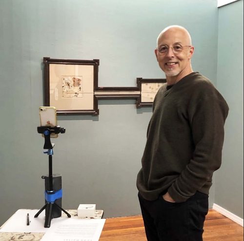 A person standing in front of a blackboard Description automatically generated with medium confidence