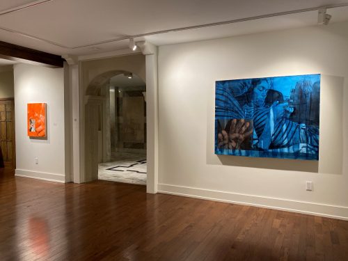 A room with a painting on the wall Description automatically generated with low confidence