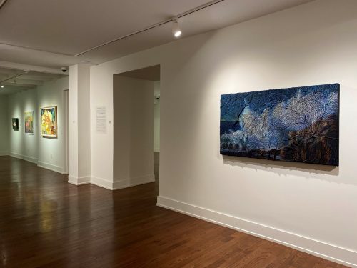 A room with paintings on the wall Description automatically generated with low confidence