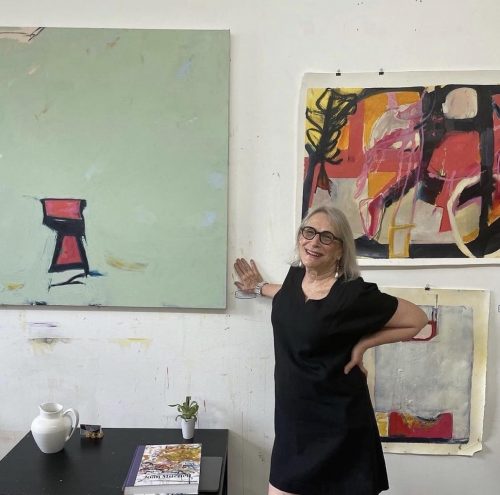 A person standing in front of a painting Description automatically generated with low confidence