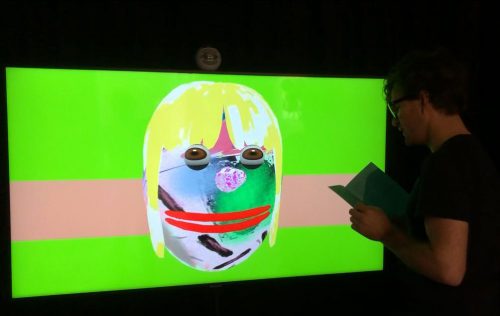 A picture containing text, person, monitor, television Description automatically generated