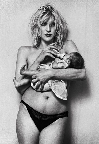 A person holding a baby Description automatically generated