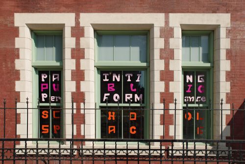 A picture containing text, building, outdoor, scoreboard Description automatically generated