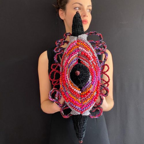 A person wearing a colorful dress Description automatically generated with low confidence