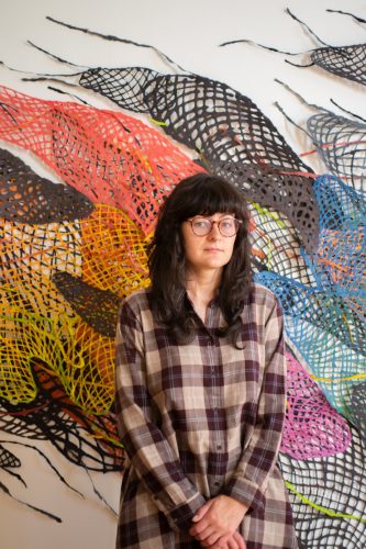 A person standing under an umbrella Description automatically generated with medium confidence