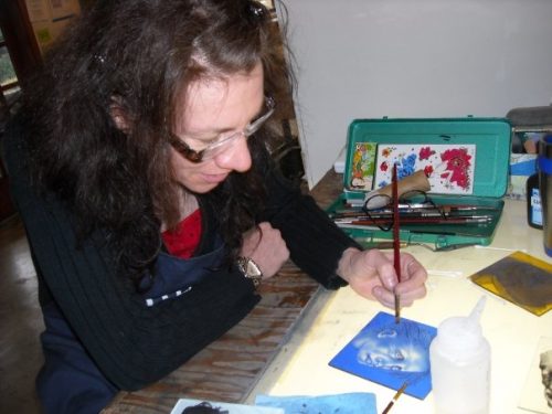 A person painting on a table Description automatically generated with medium confidence