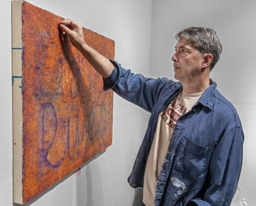 A person painting a picture Description automatically generated with medium confidence