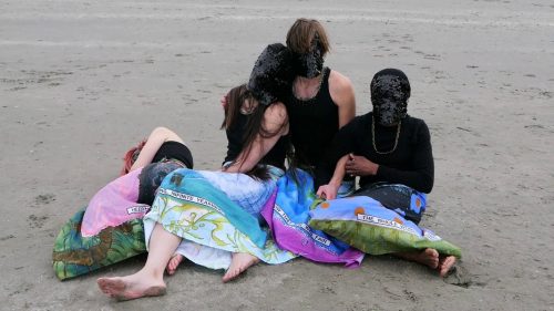 A group of people on a beach Description automatically generated with medium confidence