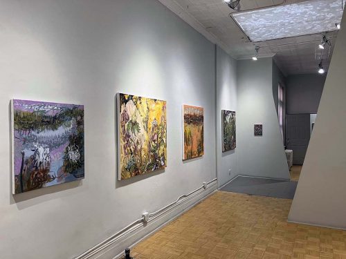 A hallway with art on the wall Description automatically generated with low confidence