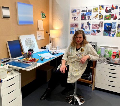 A person sitting at a desk Description automatically generated