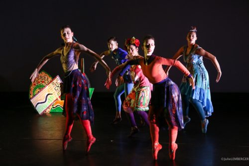 A group of people dancing on a stage Description automatically generated