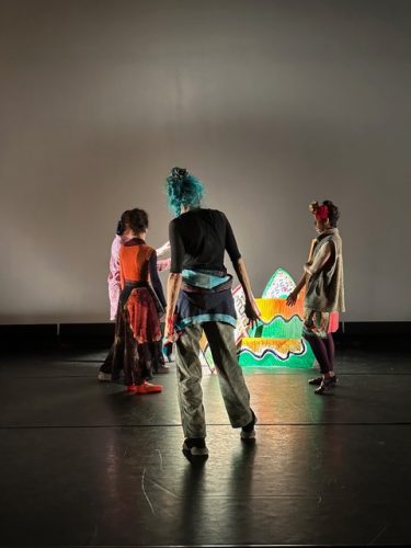 A group of people on a stage Description automatically generated