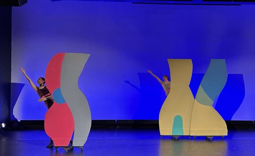 A group of people on stage Description automatically generated with low confidence