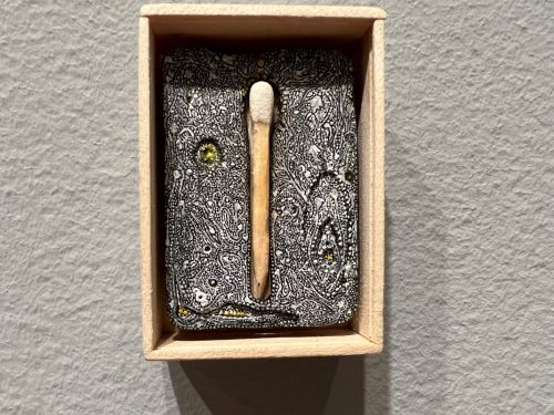 A matchstick in a box Description automatically generated with low confidence