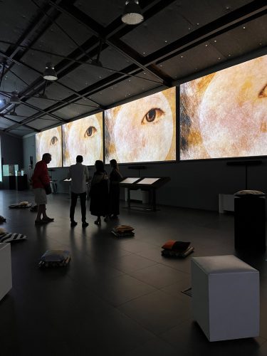 A group of people standing in a room Description automatically generated