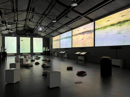 A room with large screens Description automatically generated