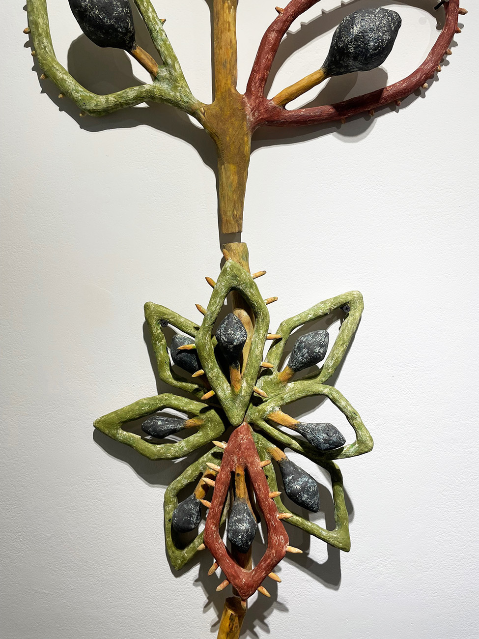 A sculpture of a plant

Description automatically generated