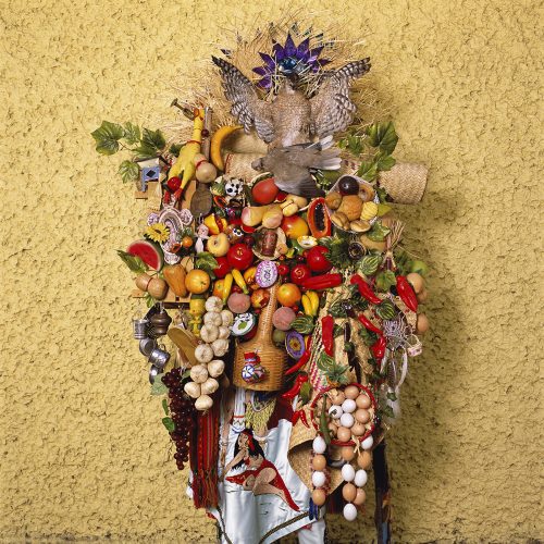 A person with a variety of fruits and vegetables Description automatically generated