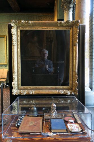 A framed picture of a person sitting in a chair Description automatically generated