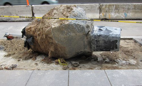 A large rock on the ground Description automatically generated