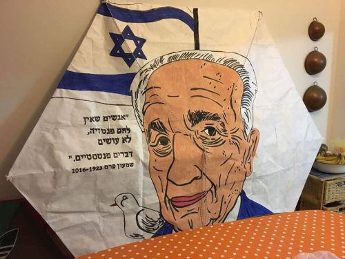 A kite with a drawing of a person Description automatically generated