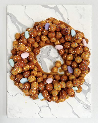 A round donut with candy on top Description automatically generated with medium confidence