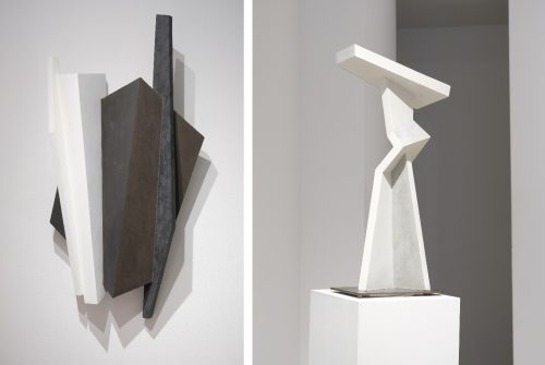 A couple of sculptures on a white surface Description automatically generated