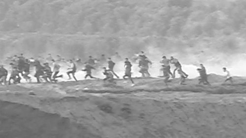 A group of people running Description automatically generated