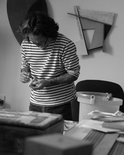 A person in a striped shirt Description automatically generated