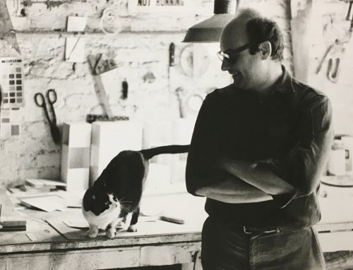 A person standing next to a cat Description automatically generated