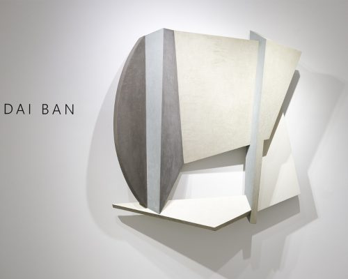 A sculpture of a boat on a wall Description automatically generated