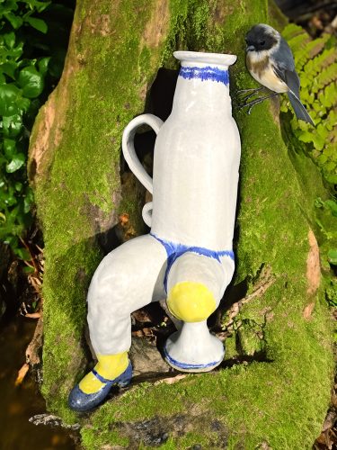 A bird sitting on a statue Description automatically generated