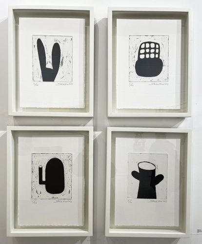 A group of framed art on a wall Description automatically generated