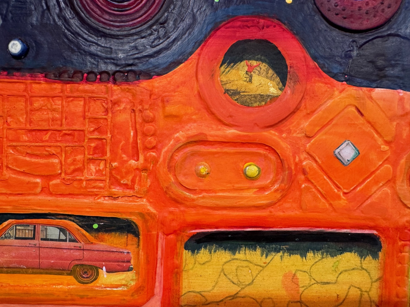 A colorful art piece with a car in the middle

Description automatically generated