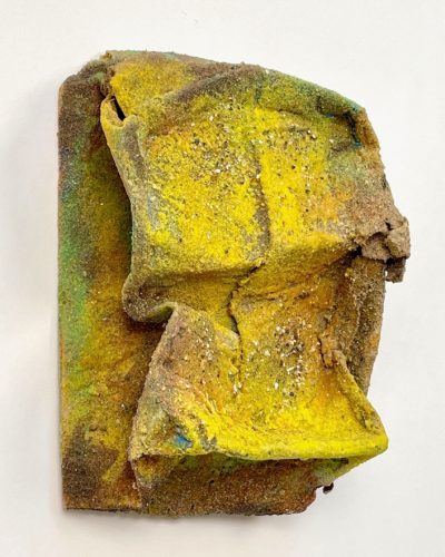 A piece of yellow and green paint Description automatically generated