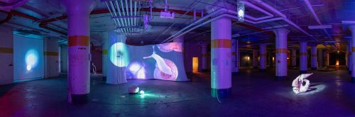 A room with a large wall with a painting on it Description automatically generated with medium confidence