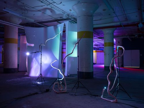 A room with lights and columns Description automatically generated