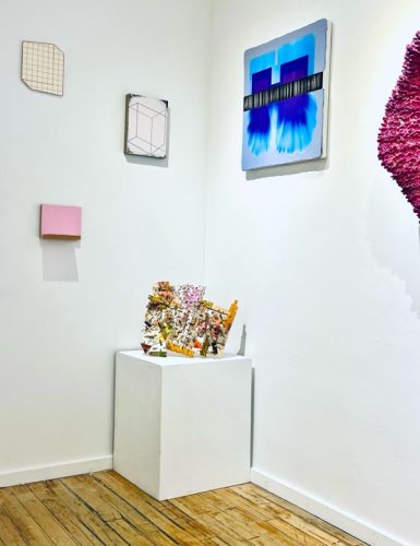 A white box with a piece of art on it Description automatically generated