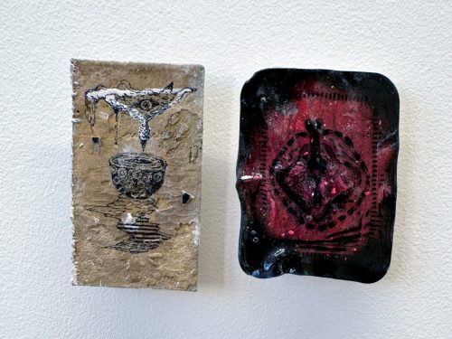 A couple of pieces of art Description automatically generated